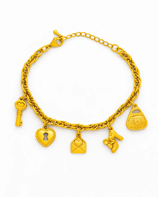 Gold bracelet with various charms on a white background