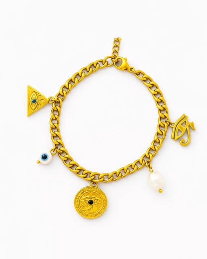 Gold chain bracelet with various charms on a white background