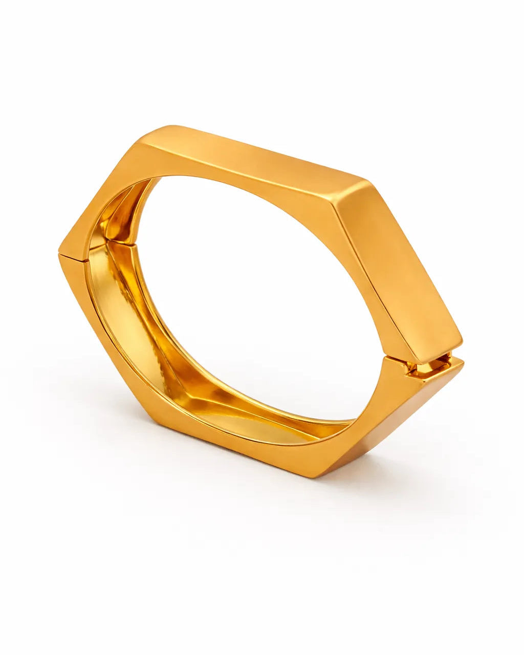 Gold ring with geometric design on a white background