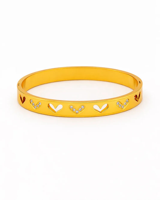 Yellow bracelet with heart and arrow designs on a white background