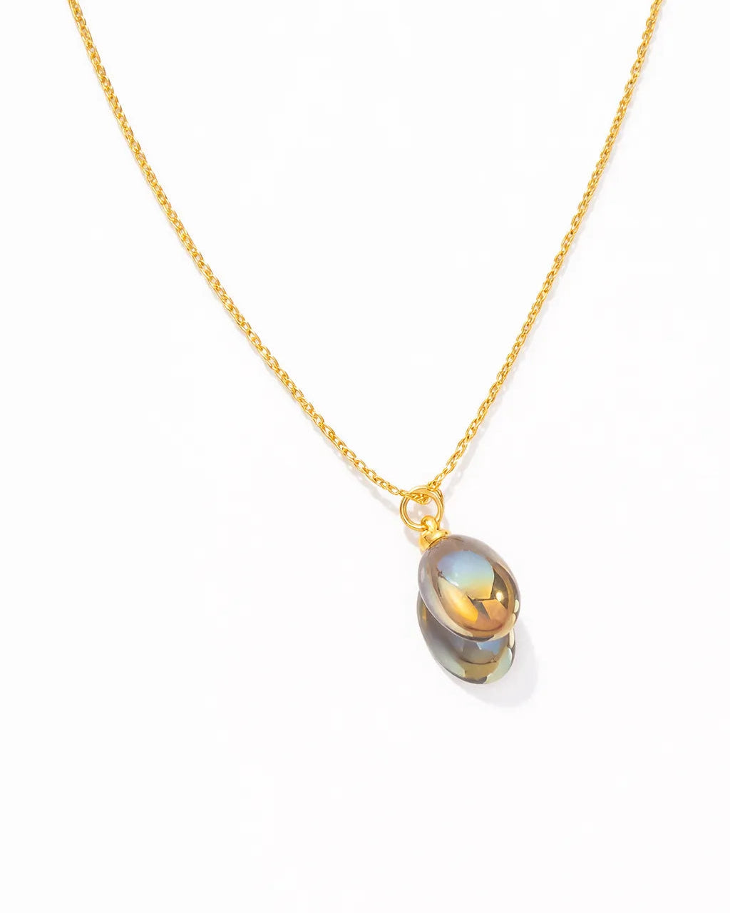 Gold necklace with a pendant on a white background