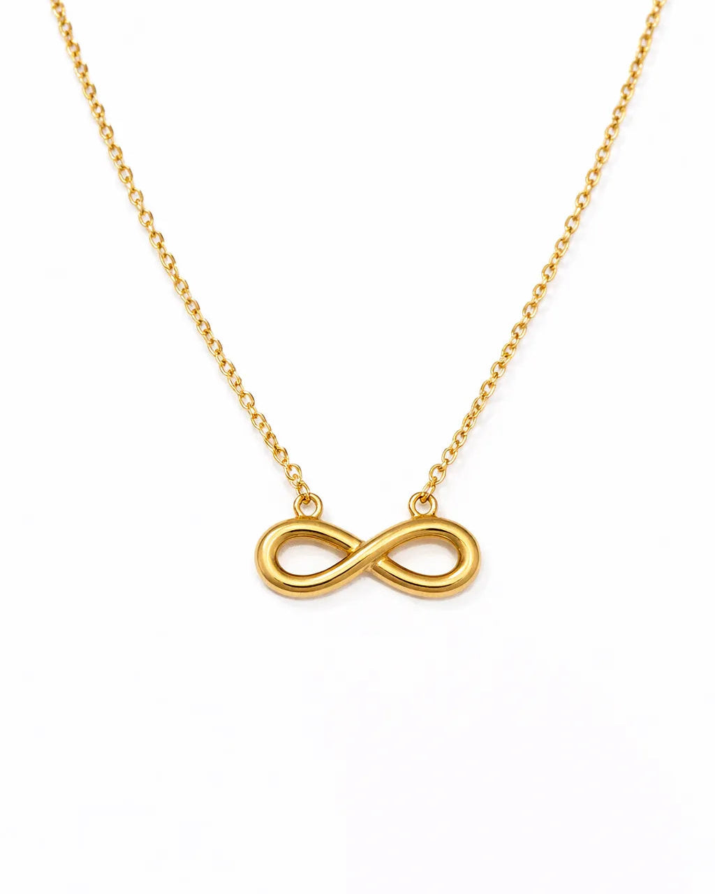 Gold infinity necklace on a white background