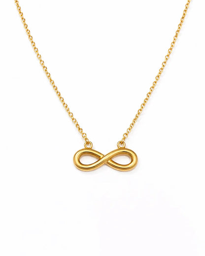 Gold infinity necklace on a white background