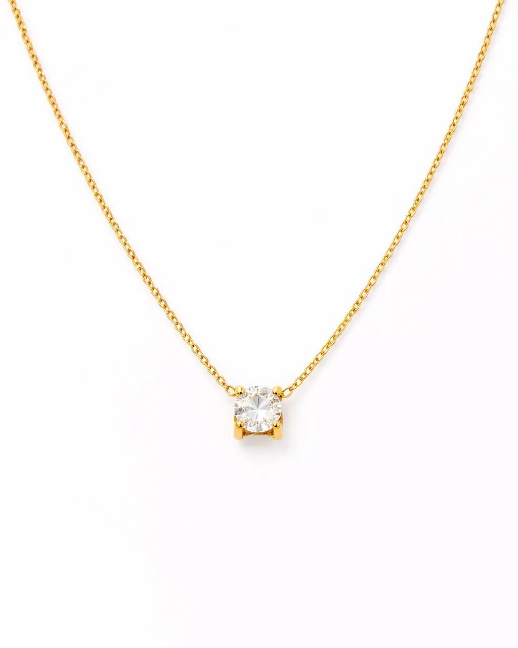 Gold necklace with a small diamond pendant on a white background