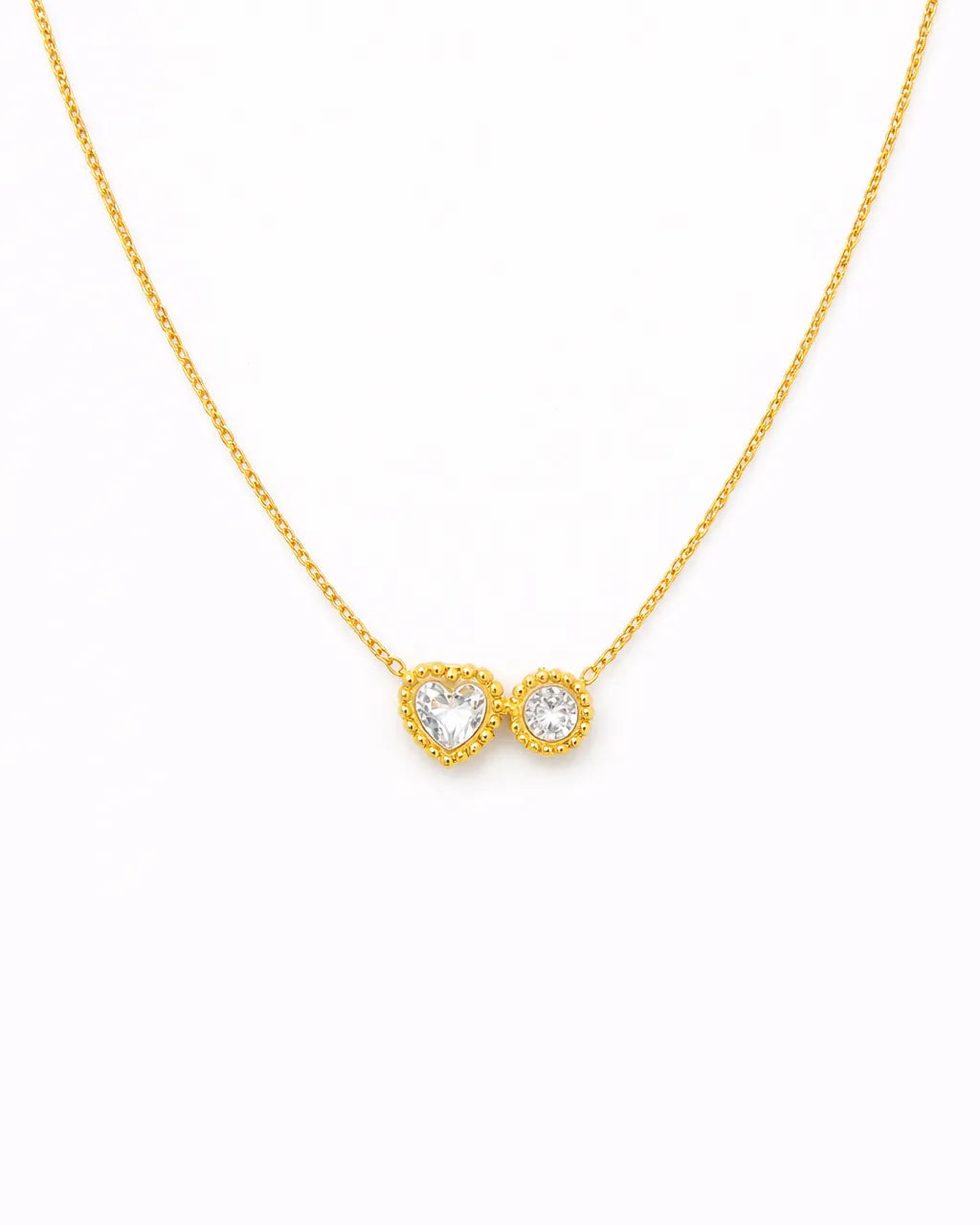 Gold necklace with a heart and infinity symbol pendant on a white background