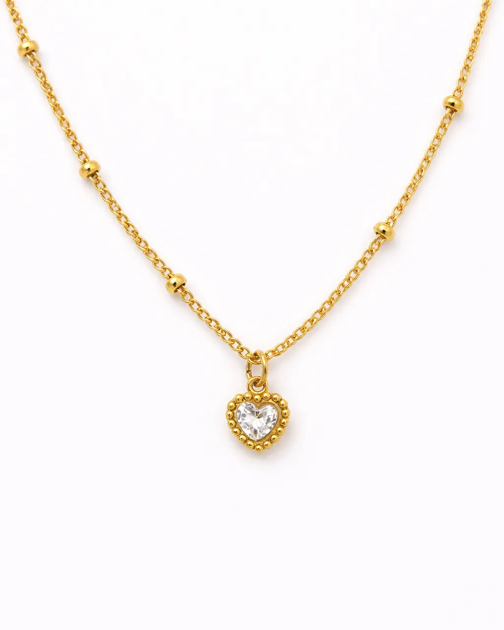 Gold necklace with a heart-shaped pendant on a white background
