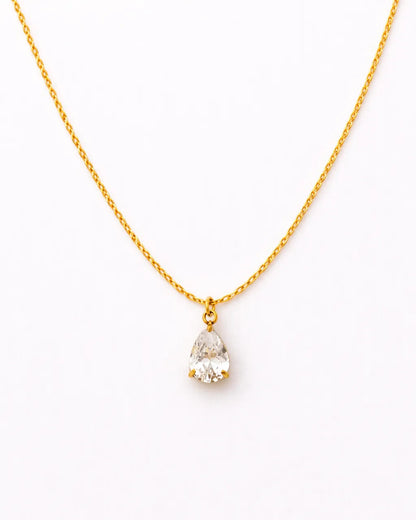 Gold necklace with a teardrop-shaped pearl pendant on a white background