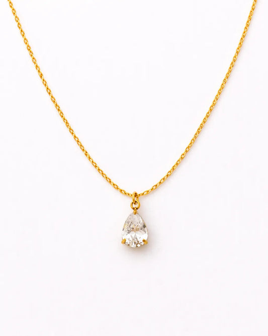 Gold necklace with a teardrop-shaped pearl pendant on a white background