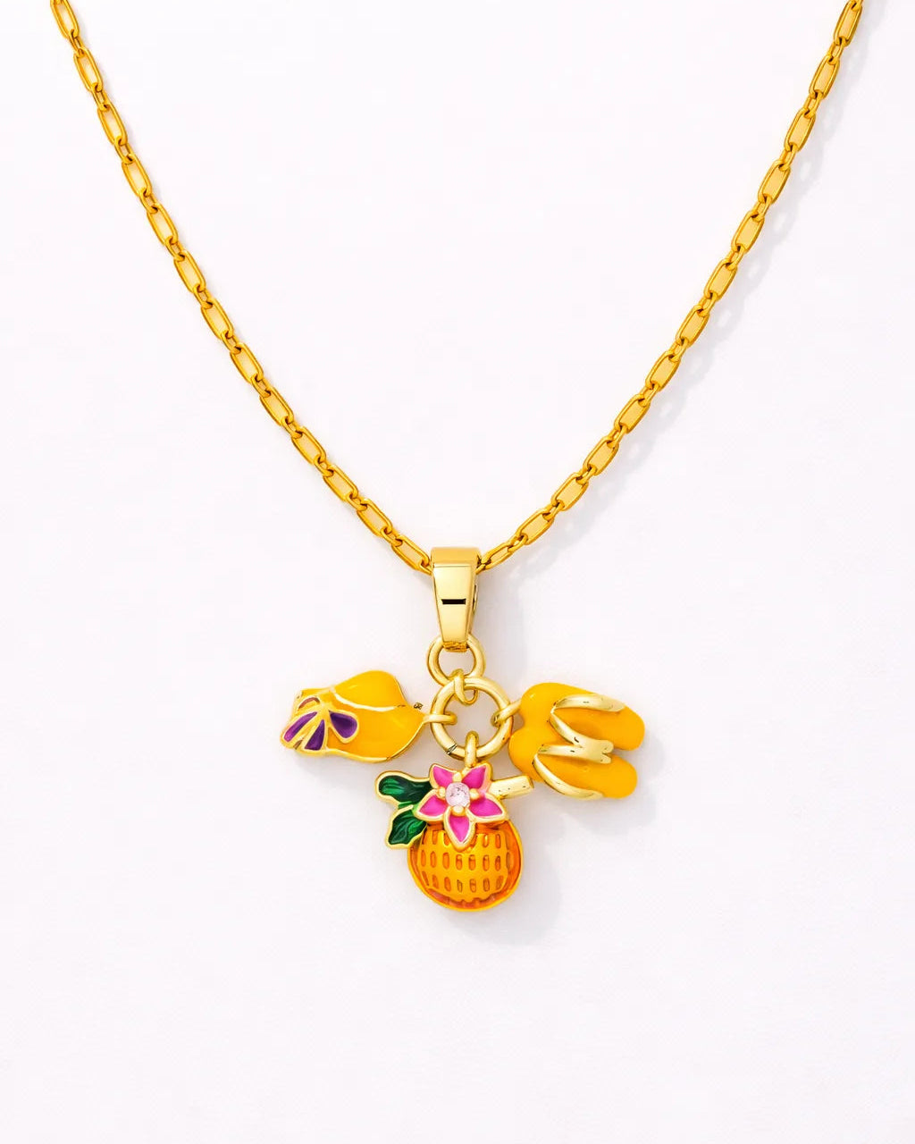 Gold necklace with colorful pineapple pendant on a white background