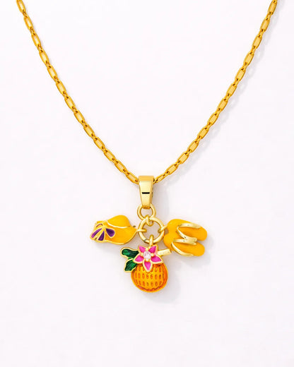 Gold necklace with colorful pineapple pendant on a white background