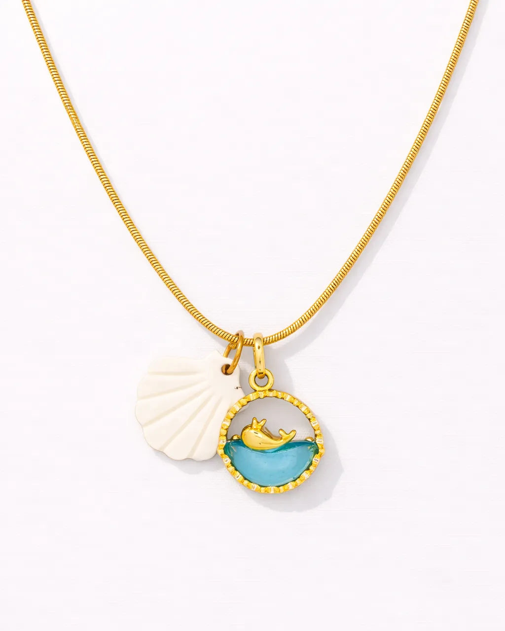 Necklace with a shell and mermaid pendant on a white background