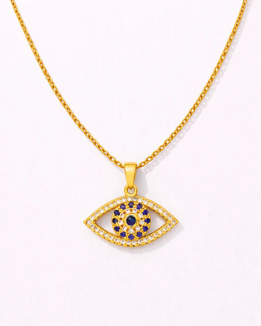 Gold necklace with an eye-shaped pendant featuring blue stones on a white background