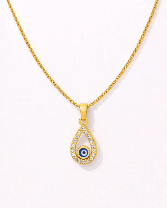 Gold necklace with a teardrop-shaped pendant featuring an eye design on a white background