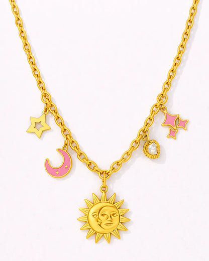 Gold necklace with sun, moon, and star charms on a white background