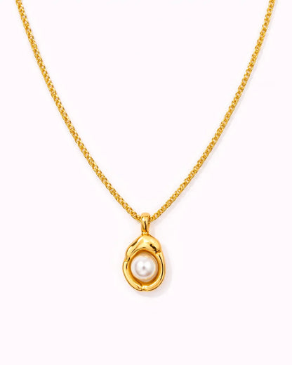 Gold necklace with a pearl pendant on a white background