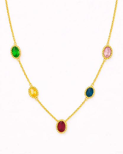 Gold necklace with colorful gemstones on a white background