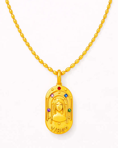 Gold pendant with colorful stones on a white background