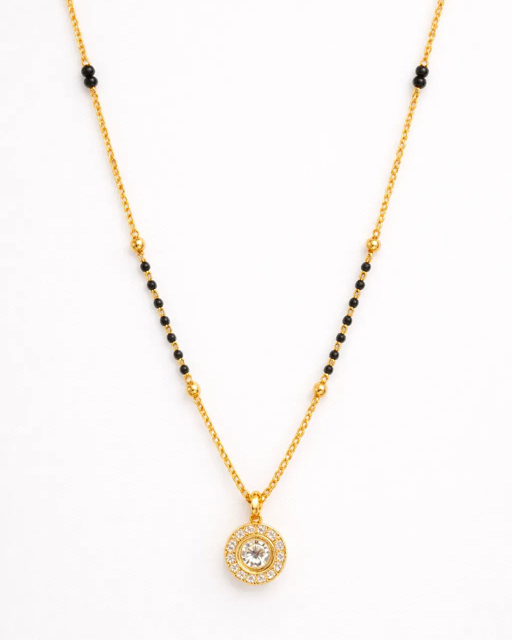 Gold necklace with a round pendant on a white background