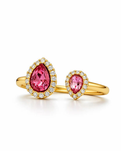 Gold ring with pink gemstones on a white background