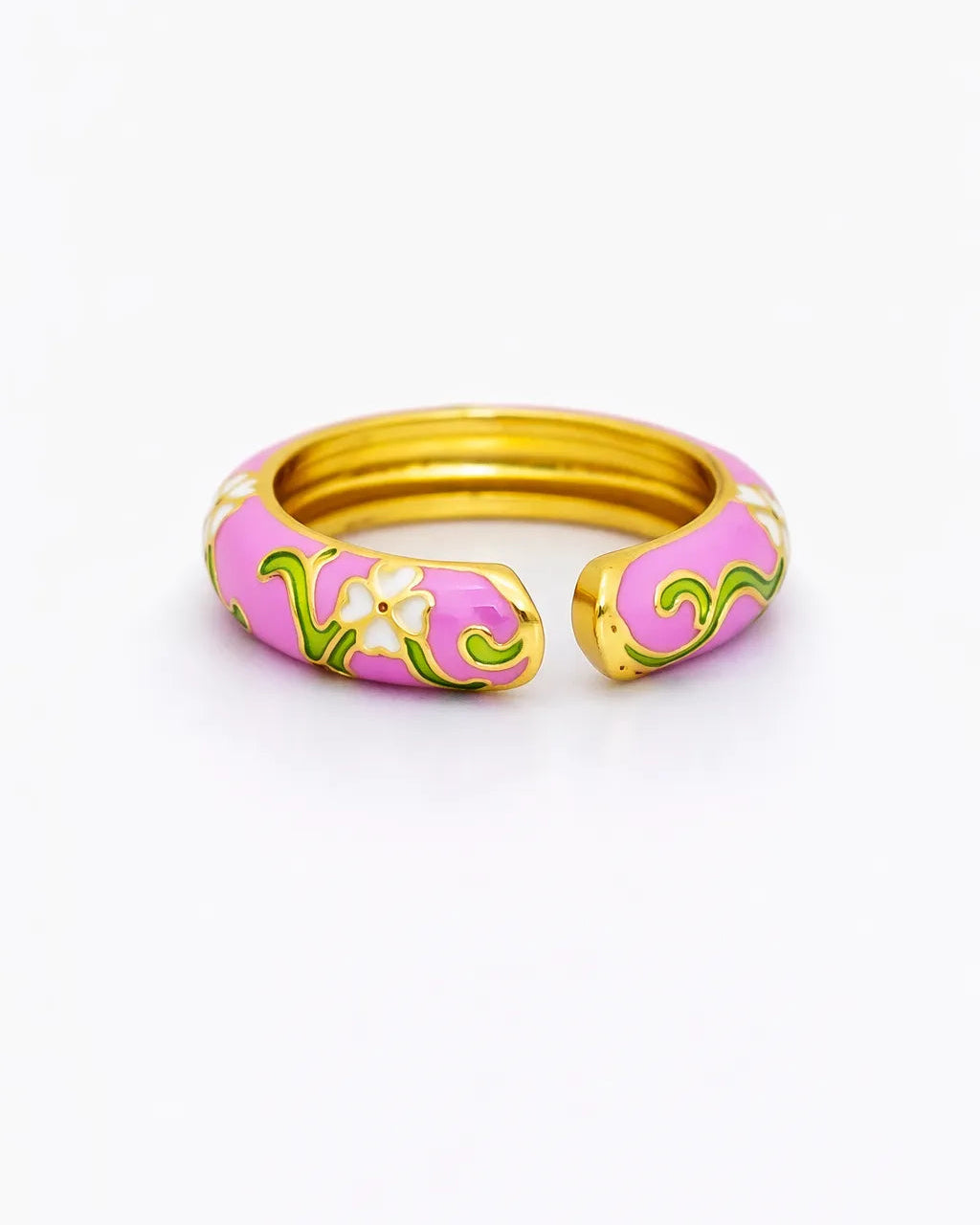 Pink and gold ring with floral design on a white background