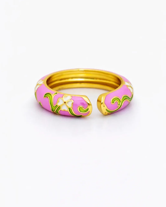 Pink and gold ring with floral design on a white background