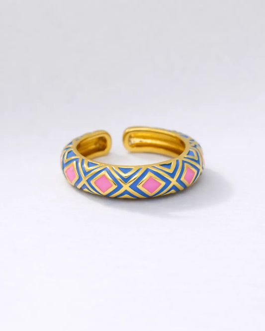 Gold and blue patterned bracelet on a white background