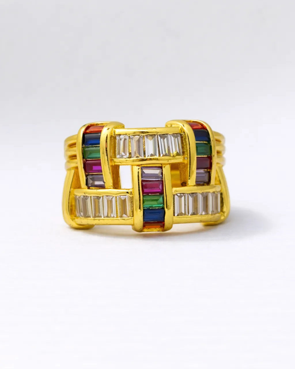 Gold ring with colorful gemstones on a white background
