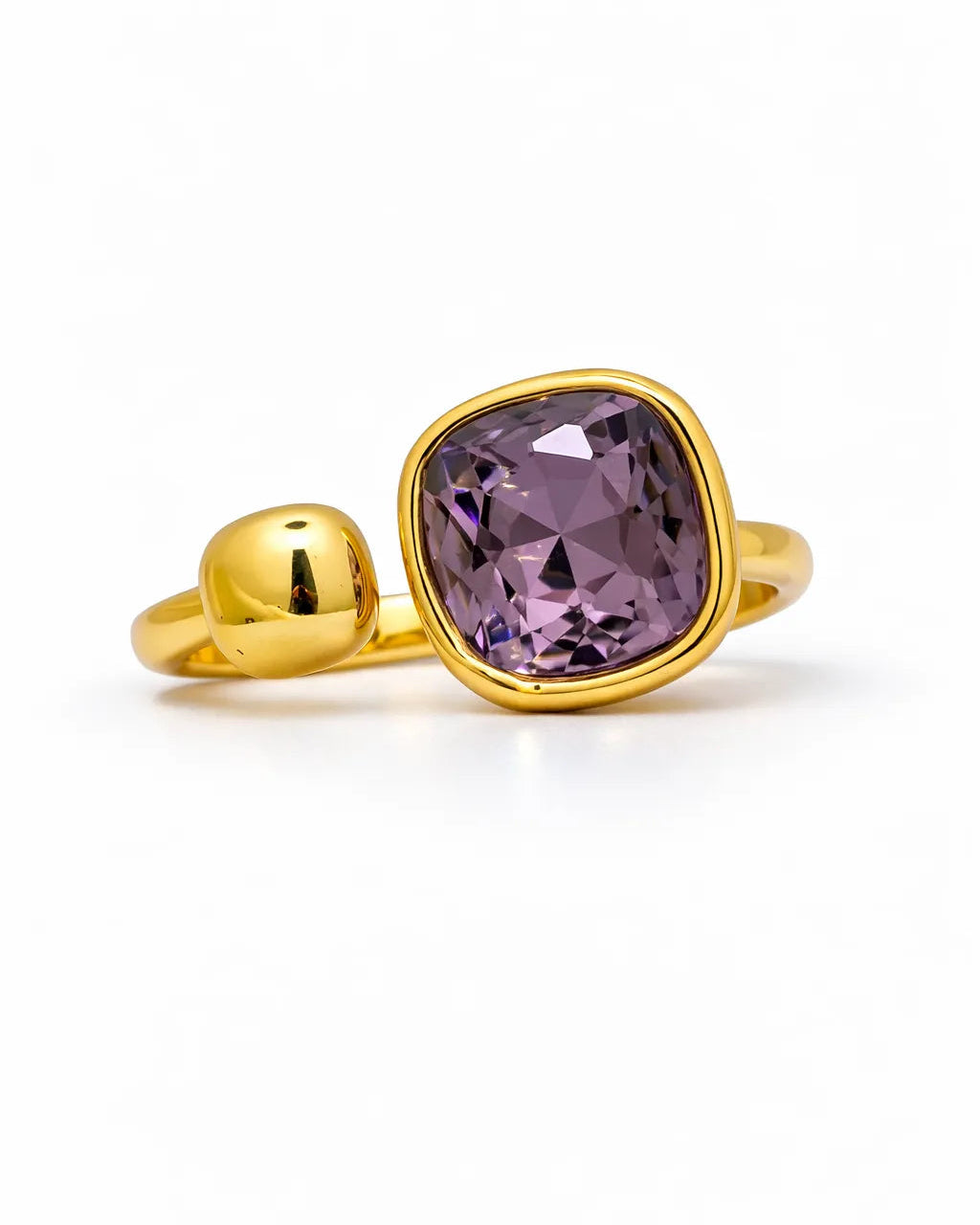 Gold ring with a purple gemstone on a white background