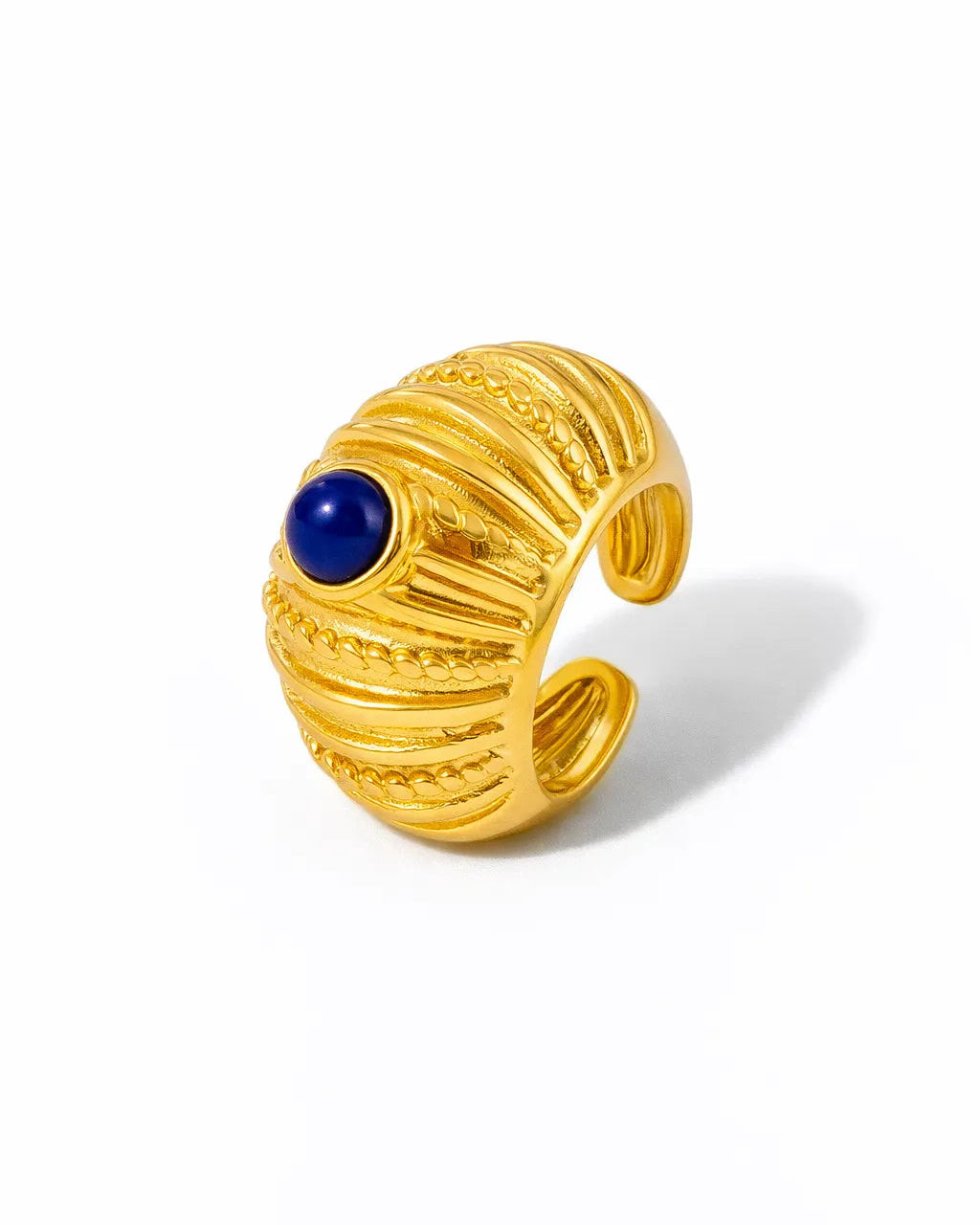 Gold ring with a blue gemstone on a white background