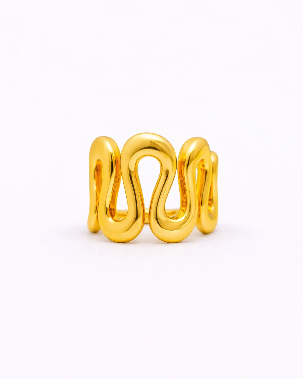 Gold ring with a wavy design on a white background