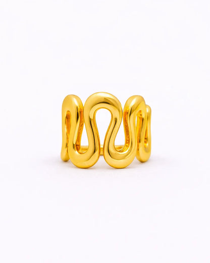Gold ring with a wavy design on a white background