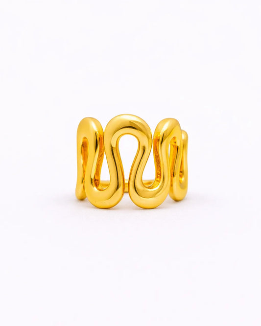 Gold ring with a wavy design on a white background
