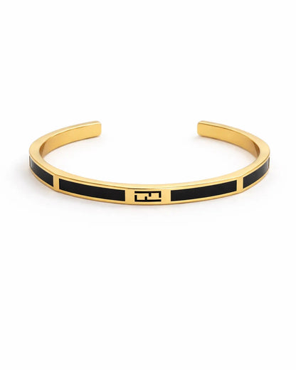Gold and black bracelet on a white background