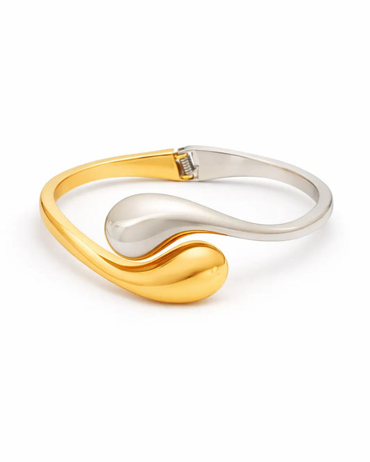 Gold and silver bracelet on a white background