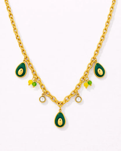 Gold necklace with green teardrop pendants on a white background