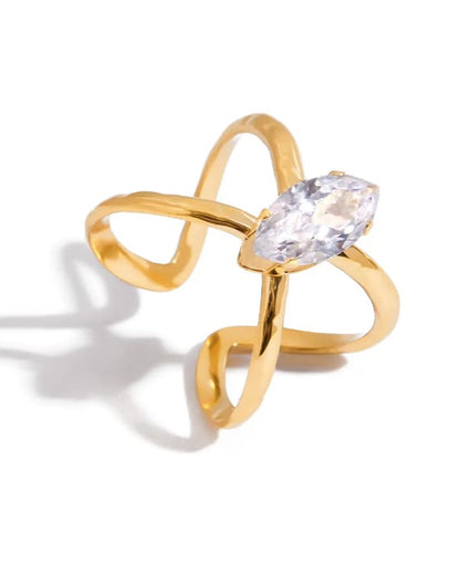 Gold ring with a clear gemstone on a white background