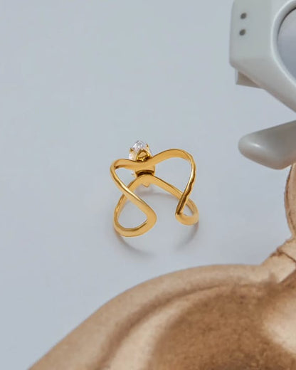 Gold butterfly-shaped earring on a light gray background